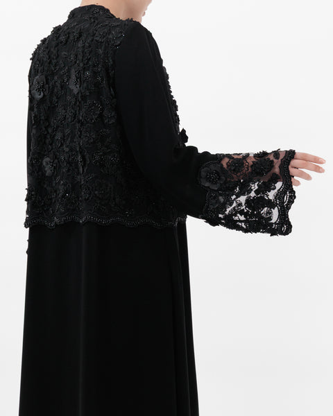 Black dress with lace sleeves on a white background