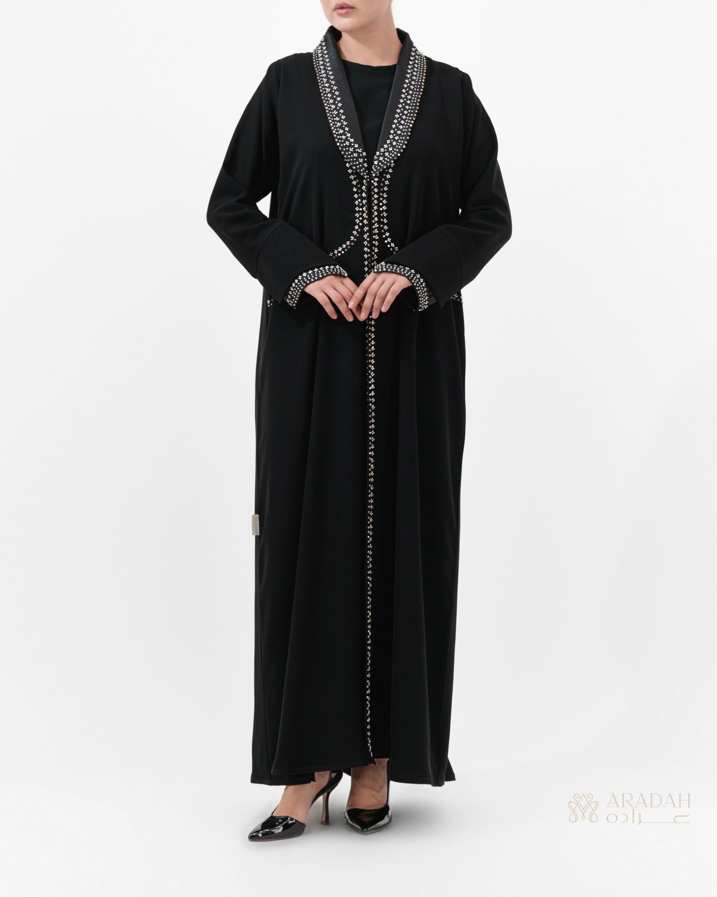 Black abaya with silver embroidery on a white background