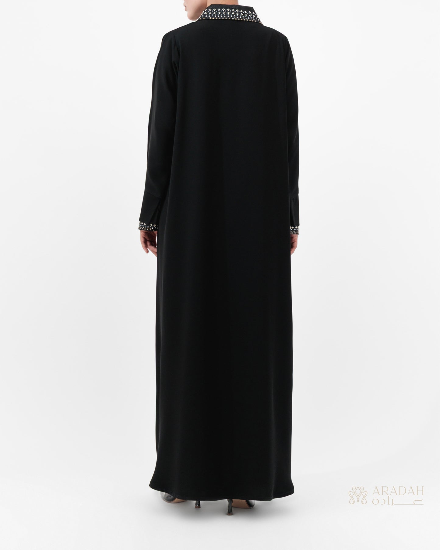 Black abaya with white embroidery on a white background