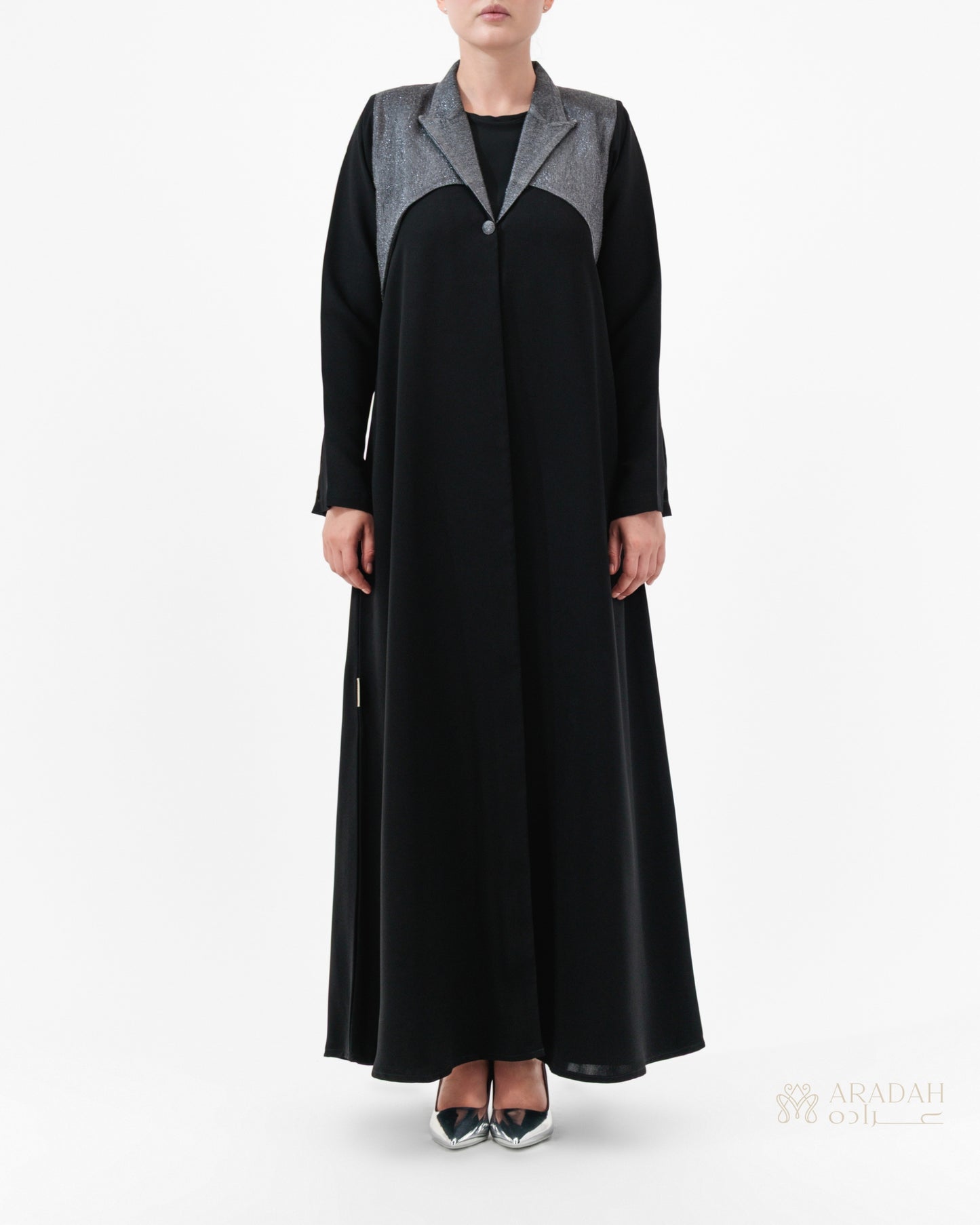 Black abaya with gray accents worn by a model on a white background