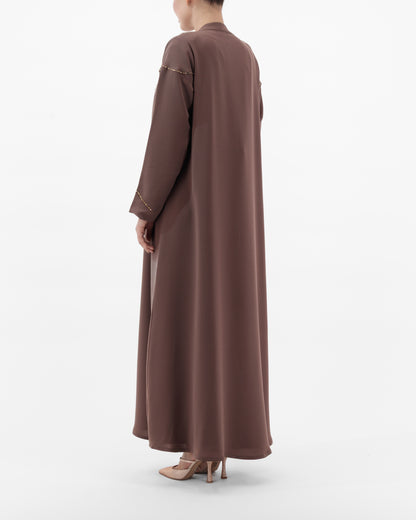 Brown long-sleeve dress worn by a person on a white background
