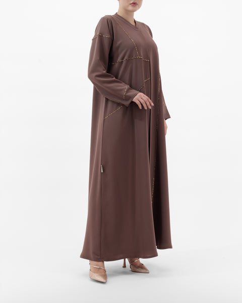 Brown long-sleeve dress worn by a person on a white background