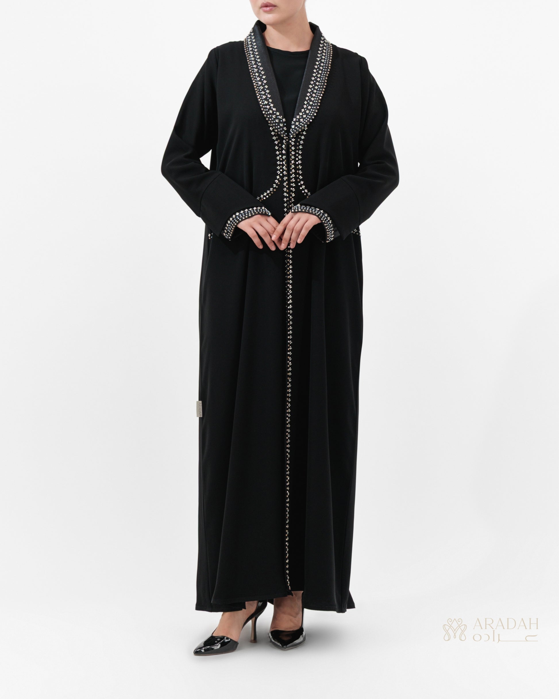 Black abaya with silver embroidery on a white background