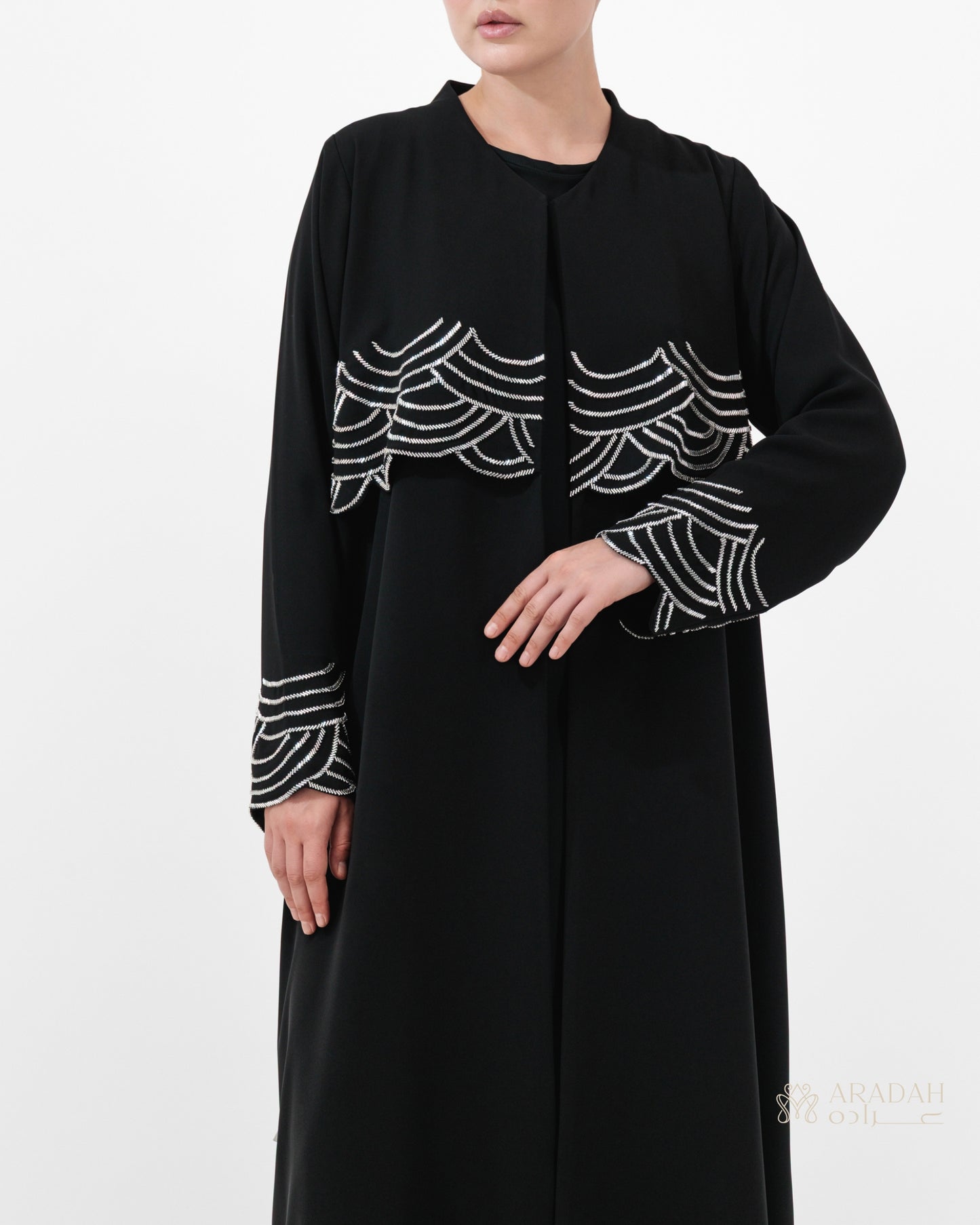 Regalia abaya — Nidha — black — wave-pattern embellishment — side profile

