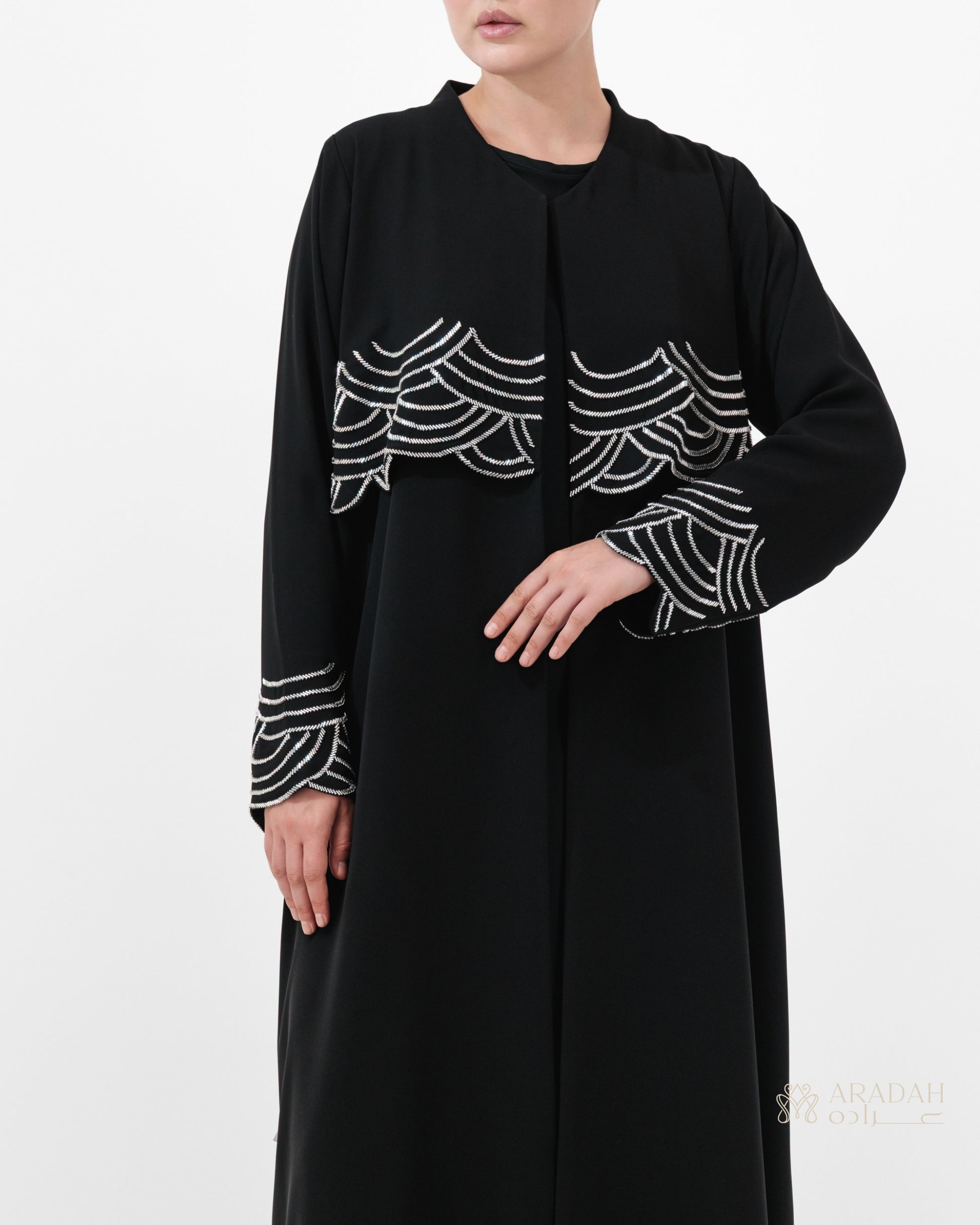 Regalia abaya — Nidha — black — wave-pattern embellishment — side profile

