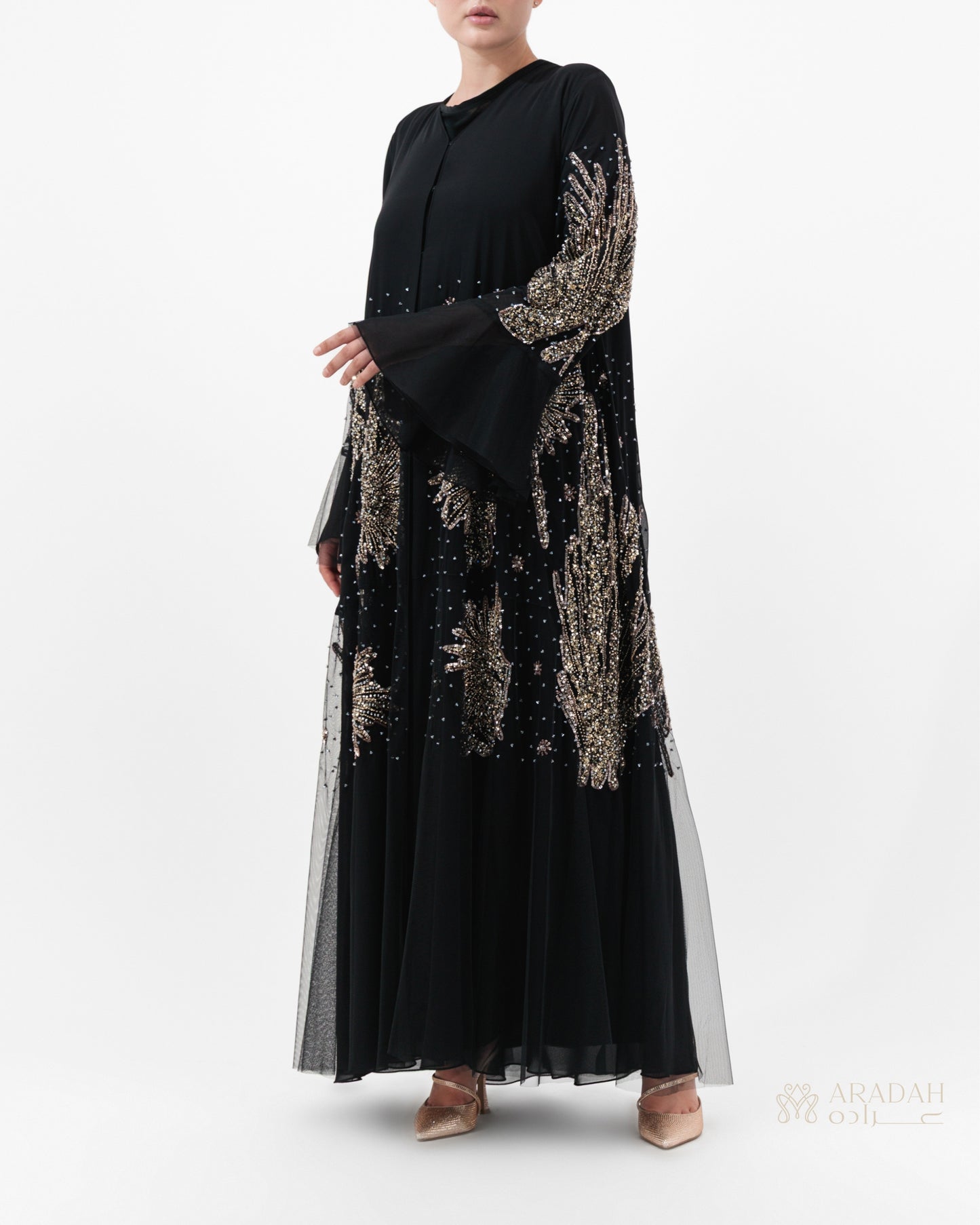 Black dress with gold embroidery on a white background