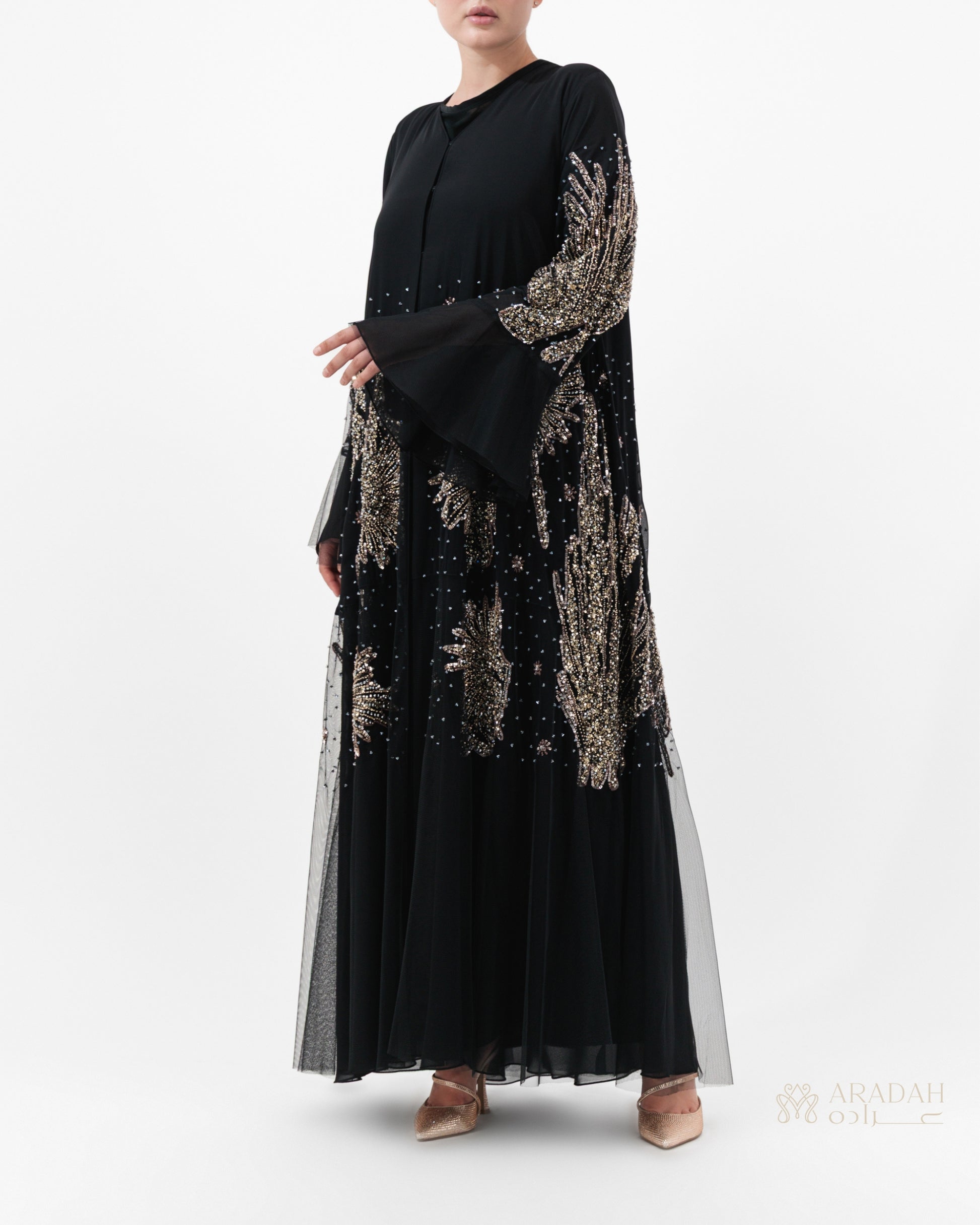 Black dress with gold embroidery on a white background
