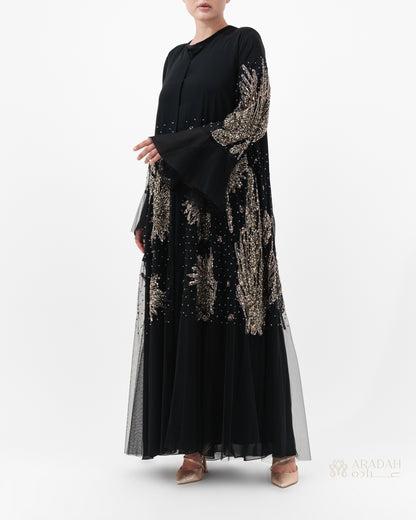 Black dress with gold embroidery on a white background