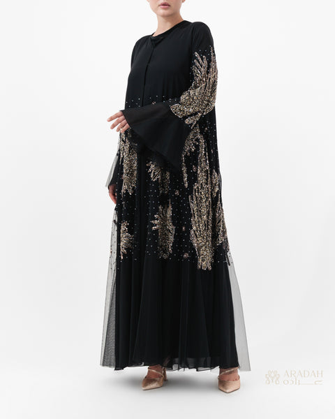 Black dress with gold embroidery on a white background