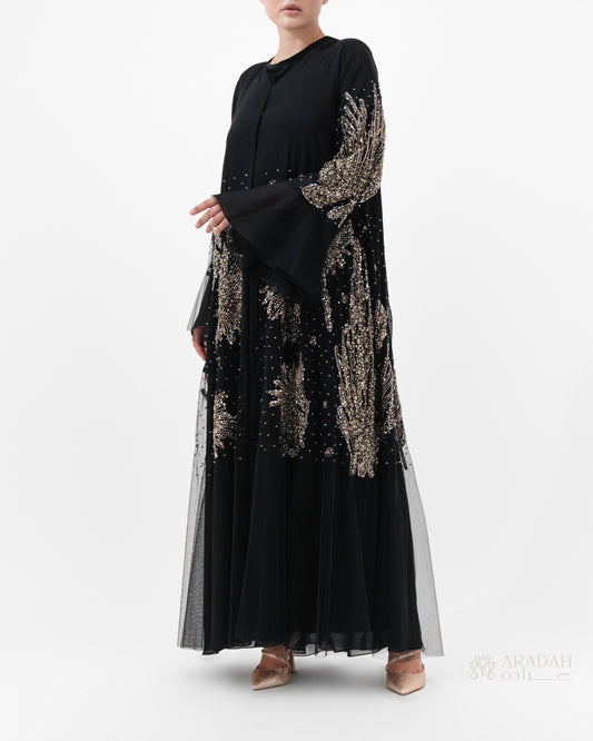 Black dress with gold embroidery on a white background