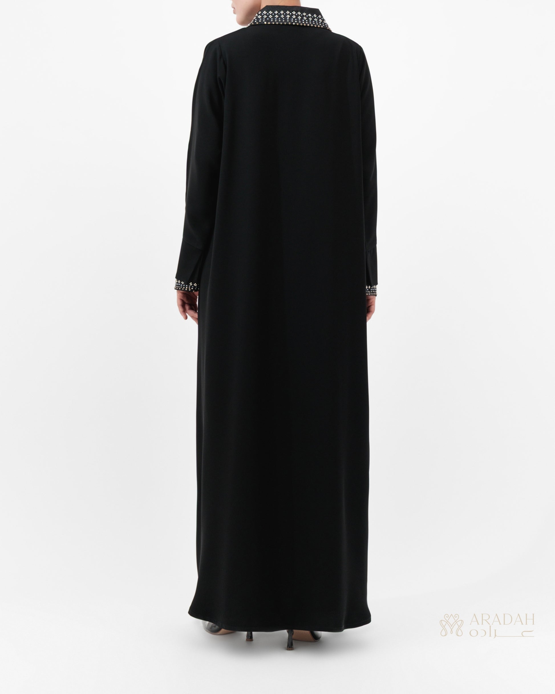Black abaya with white embroidery on a white background