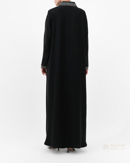 Black abaya with white embroidery on a white background