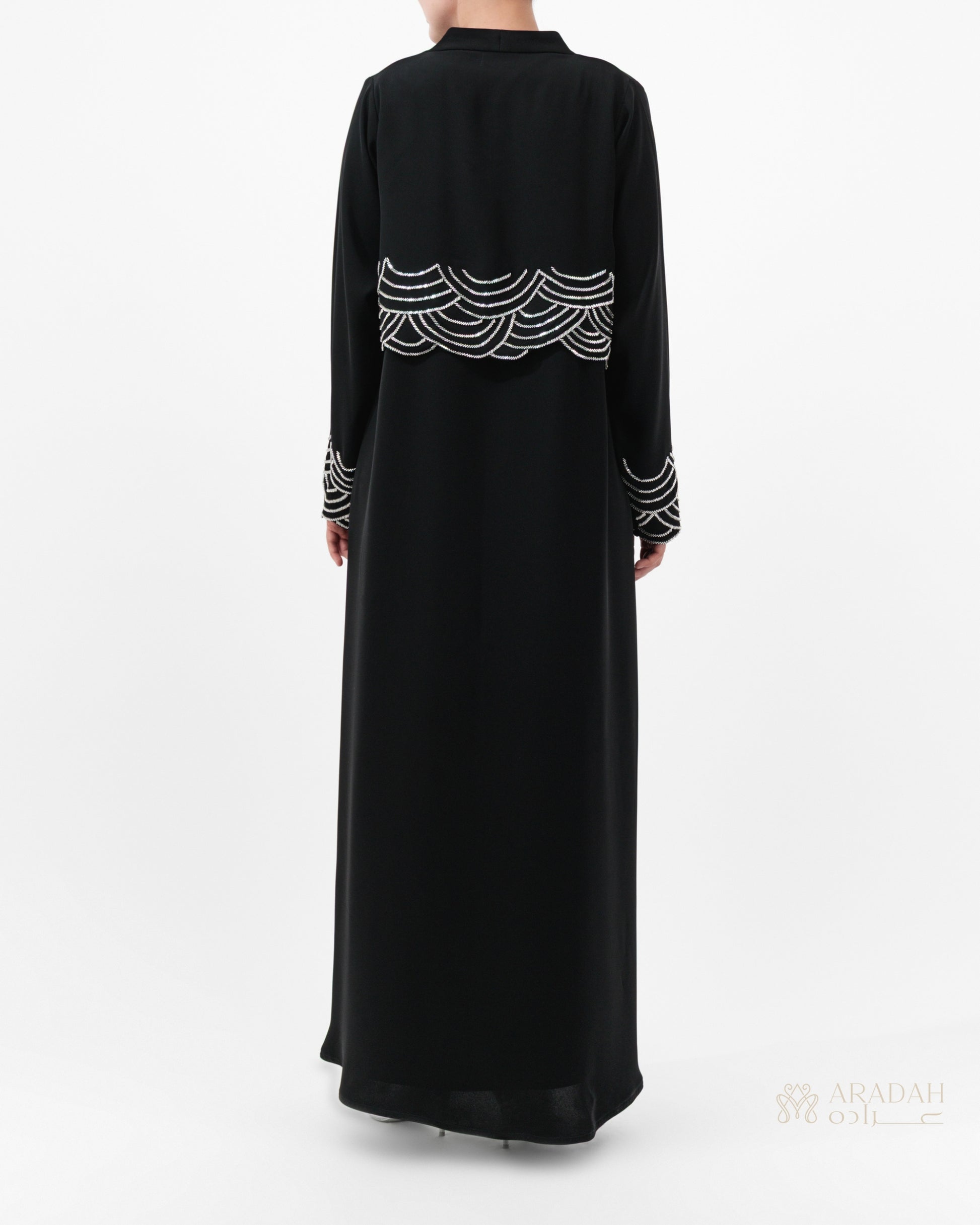 Regalia abaya — Nidha — black — cape-style overlay — back view

