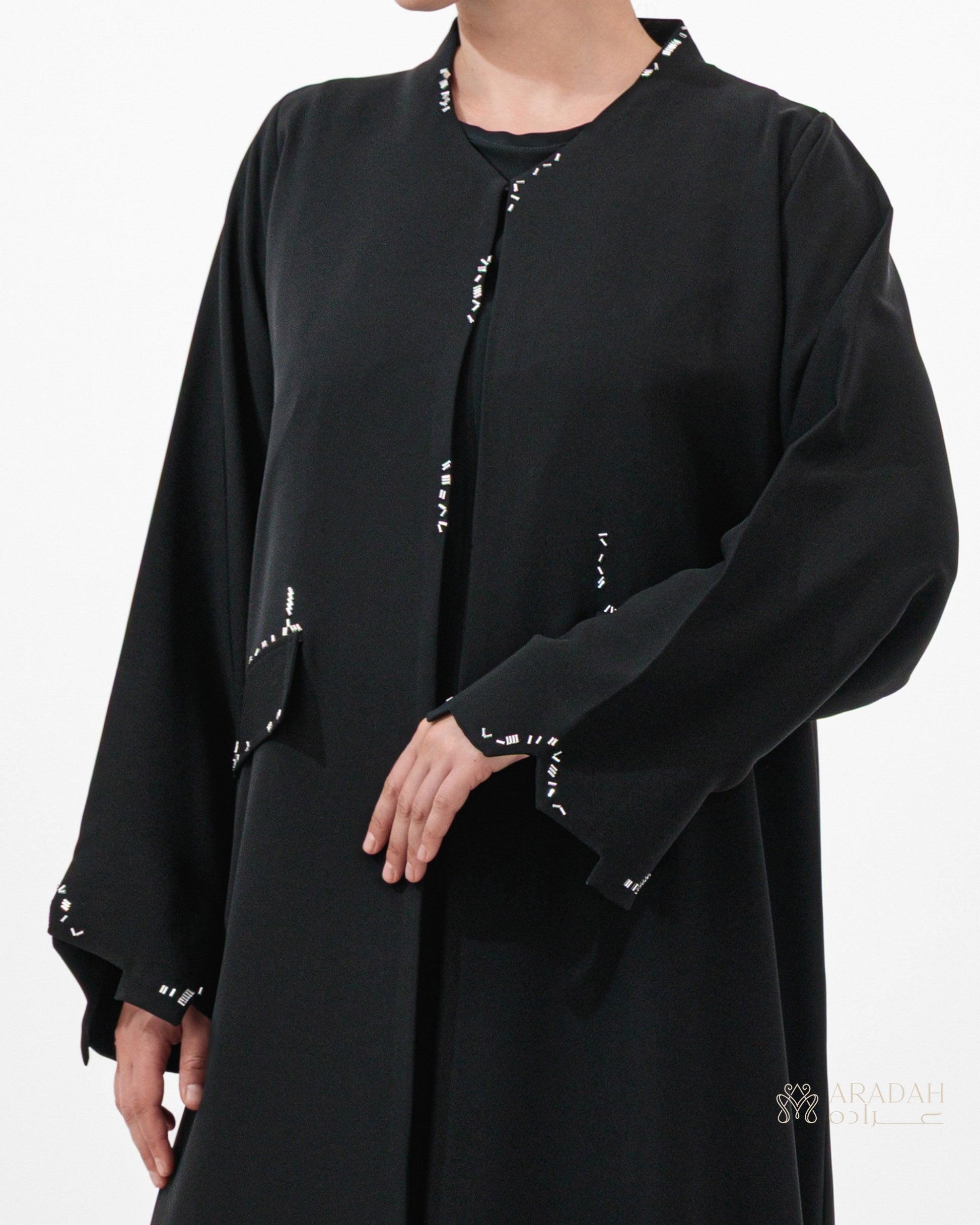 Scattered Silence abaya — Nidha — black — back view

