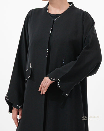 Scattered Silence abaya — Nidha — black — back view

