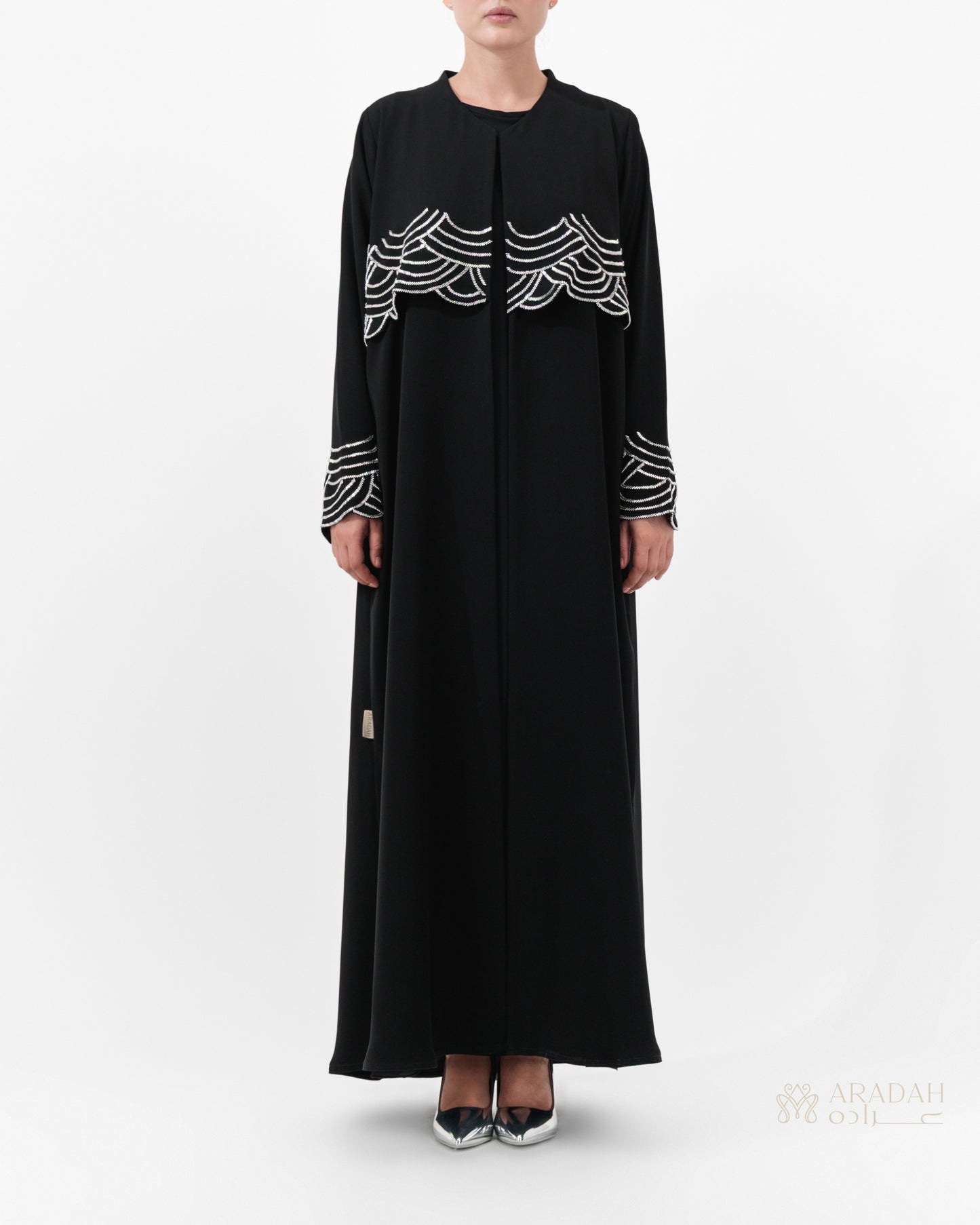Regalia abaya — hand-applied wave embellishments on cuffs — detail

