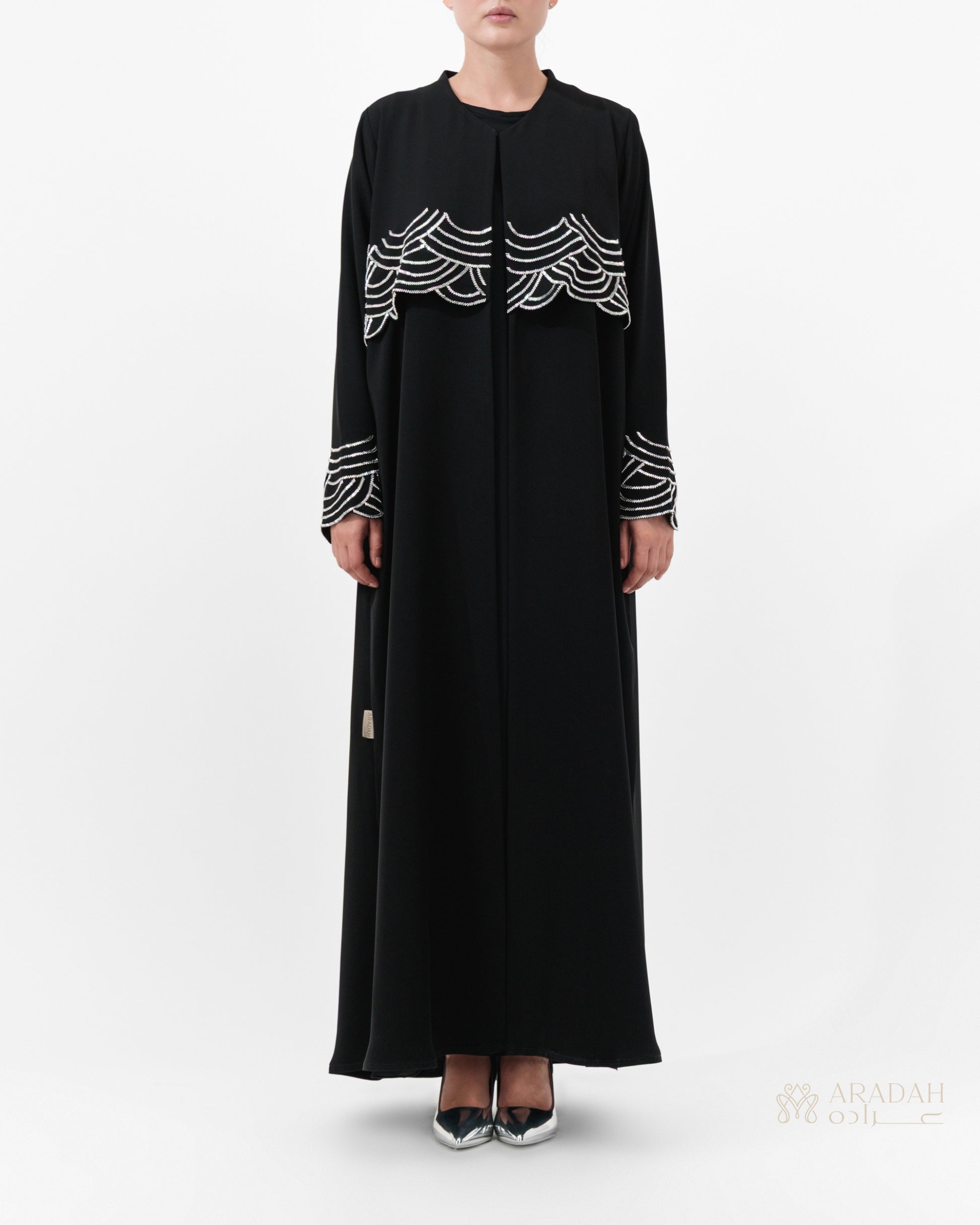 Regalia abaya — hand-applied wave embellishments on cuffs — detail


