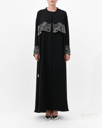 Regalia abaya — hand-applied wave embellishments on cuffs — detail

