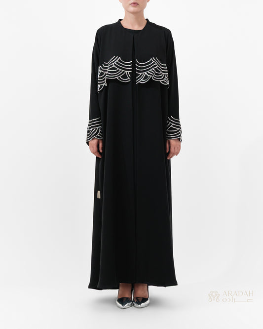 Regalia abaya — hand-applied wave embellishments on cuffs — detail

