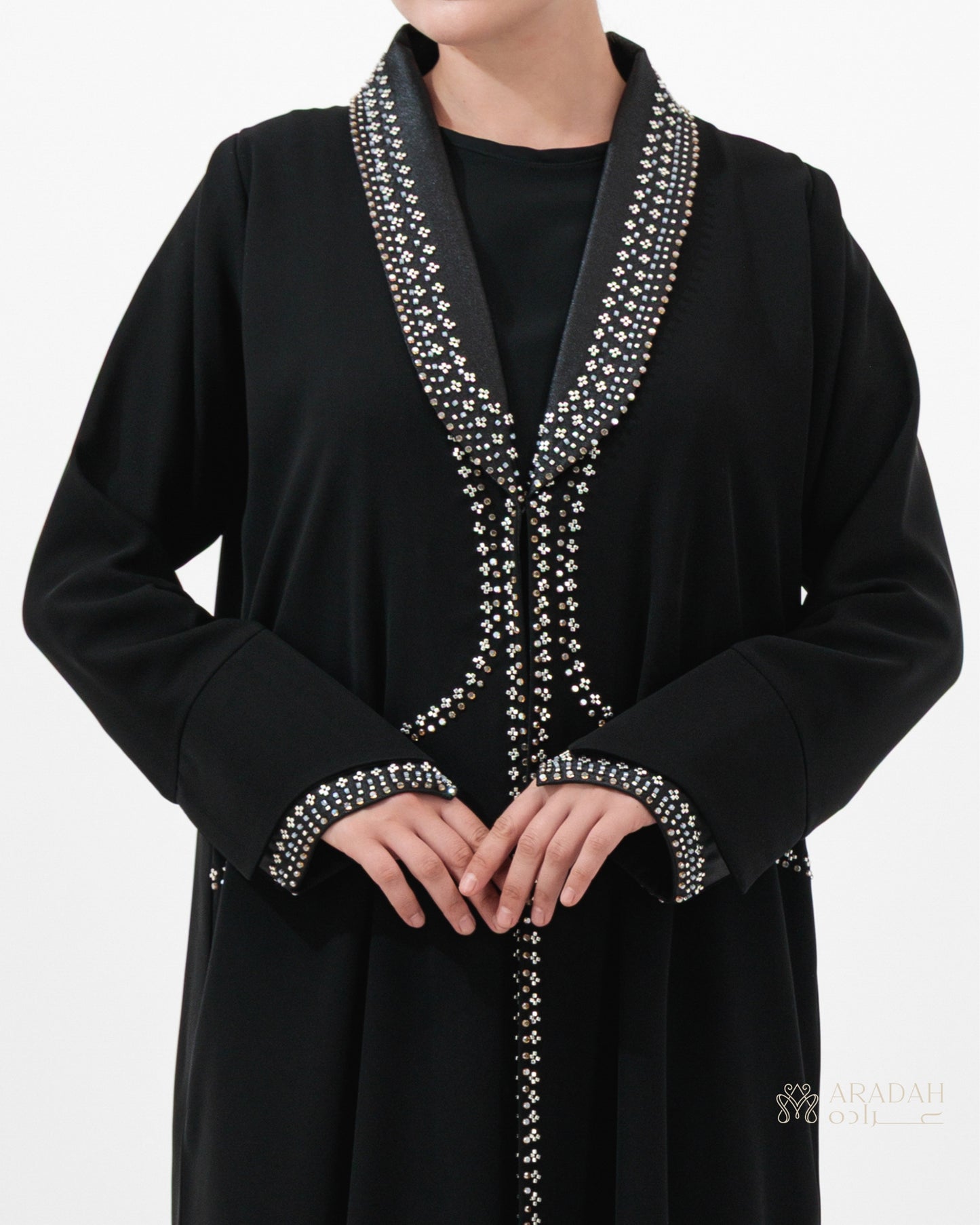 Black abaya with silver embroidery on a white background