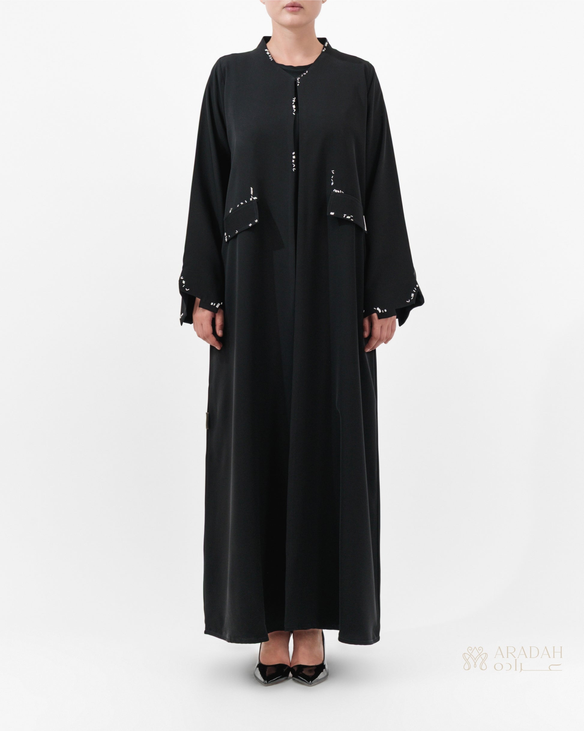 Scattered Silence abaya by Aradah — Nidha fabric — black — front view

