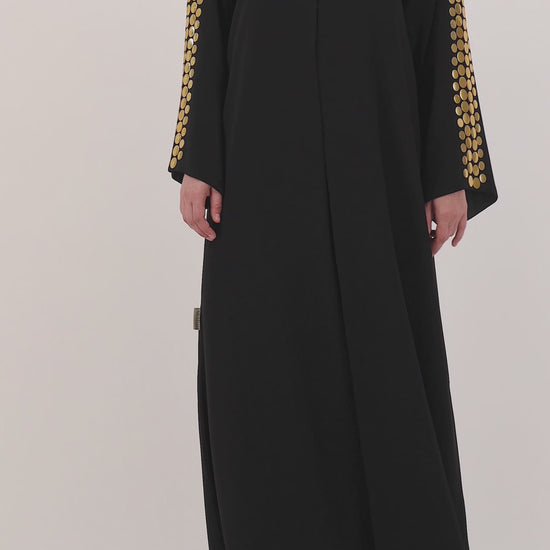 Helia abaya — large hand-applied gold discs on sleeves — detail

